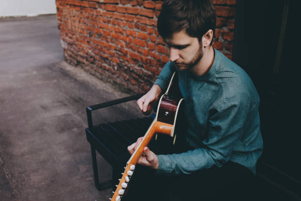 istock Hipster musician plays the guitar. 843252712