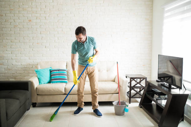 istock Independent man sweeping the house 843252816