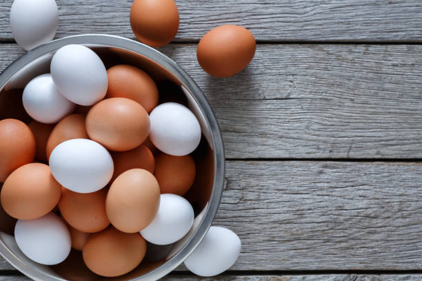 istock Fresh brown eggs in bowl on wood background 843252938