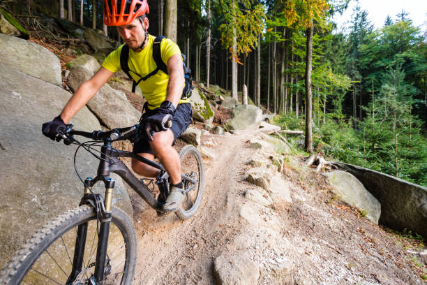 istock Mountain biker riding cycling in autumn forest 843253030