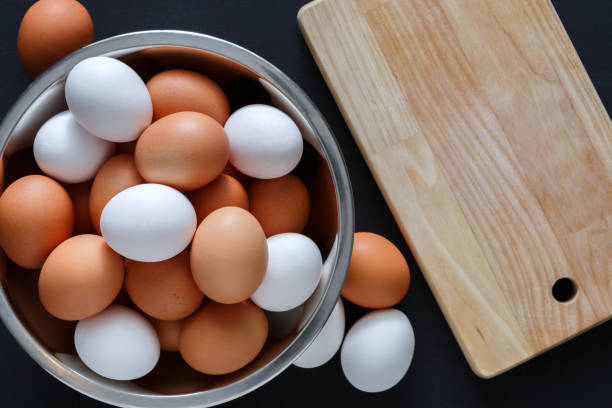 istock Fresh brown eggs in bowl isolated on black background 843253074