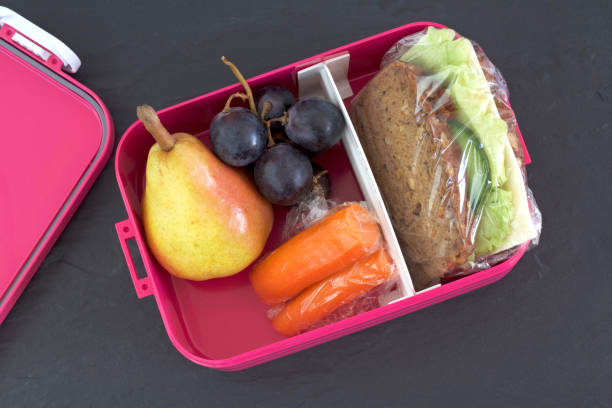 istock Healthy lunch box, cheese sandwich, pear, carrots and grapes 843257780