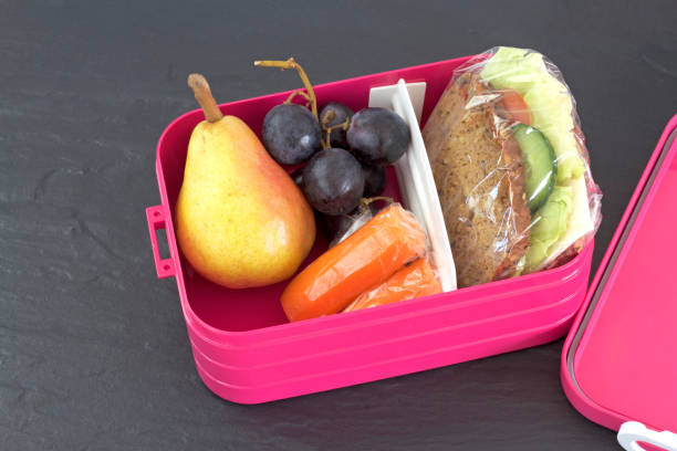 istock Healthy lunch box, cheese sandwich, pear, carrots and grapes 843257838