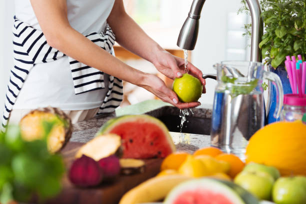 istock Healthy woman washing apple 843257924