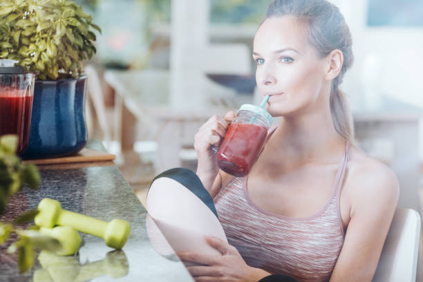istock Sportswoman drinking healthy red coctail 843259998