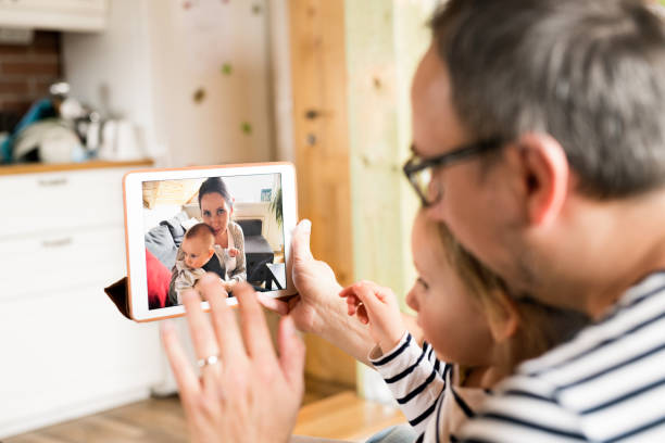 istock Young father videochatting with mother on tablet. 843261174