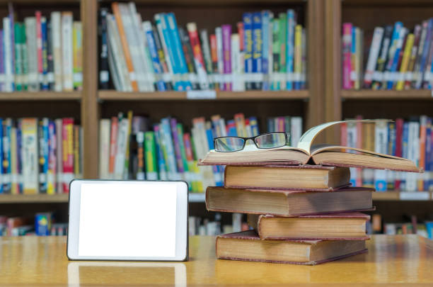 old book on the desk in library with tablet and glasses old book on the desk in library with tablet and glasses peoples alliance for democracy stock pictures, royalty-free photos & images