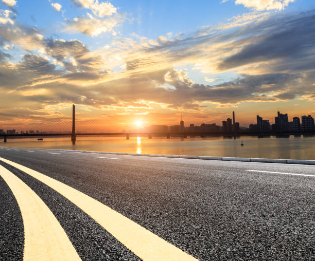 istock Asphalt highways and city buildings at sunset 843264012