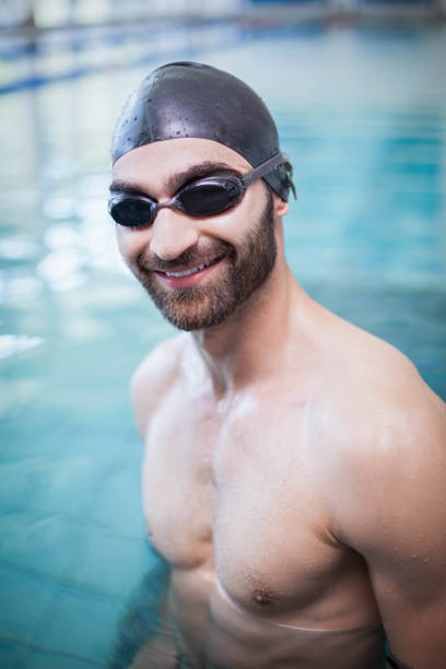 istock Smiling man wearing swim cap and goggles 843264906