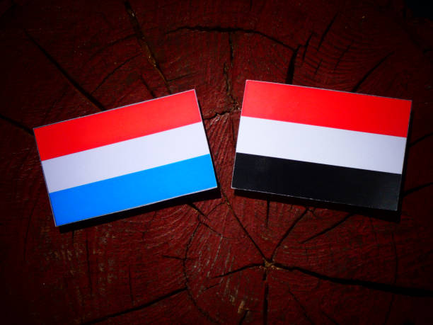 istock Luxembourg flag with Yemeni flag on a tree stump isolated 843266036