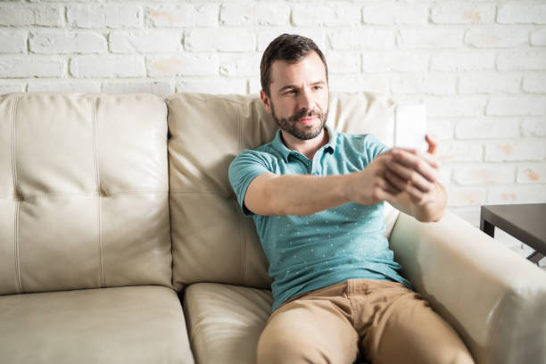istock Latin man posting a selfie on social media 843266062