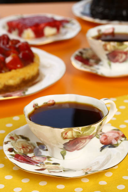 istock Black tea in a porcelain cup with a cake background 843266266