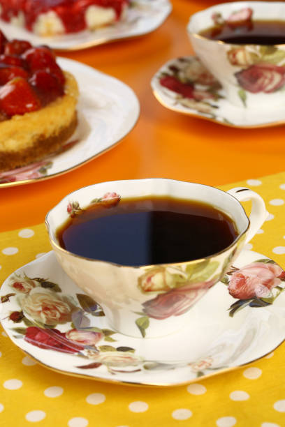 istock Black tea in a porcelain cup with a cake background 843266270