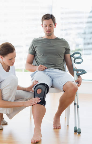 istock Physiotherapist examining man with crutches 843270636
