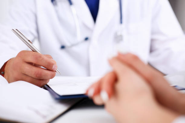 istock Male doctor arm hold silver pen 843270766