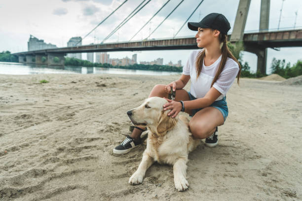 istock woman with dog on beach 843271294