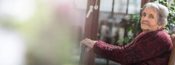 istock Old woman with her hands on a cane 843272250