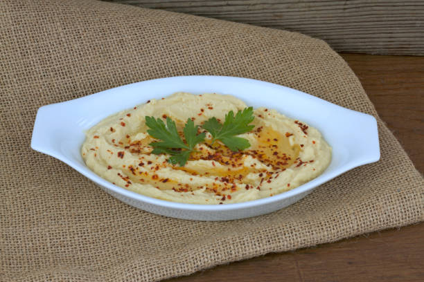 istock Delicious hummus,  (  chickpea paste, tahini, lemon, garlic  olive oil, cumin and red pepper flakes ) This is an Arab and Middle East origin appetizer meal. 843275824
