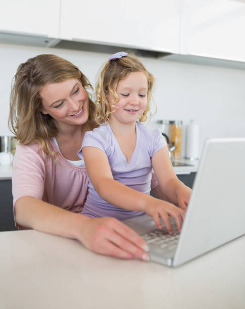 istock Mother and daughter using laptop together 843276912