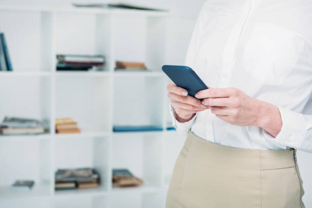 istock businesswoman messaging with smartphone 843278010