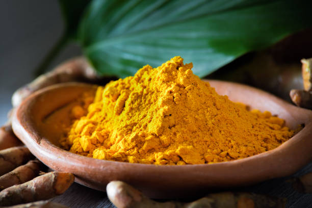 istock Turmeric powder on wooden background 843280454
