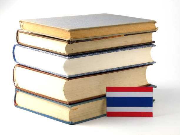istock Thai flag with pile of books isolated on white background 843289748
