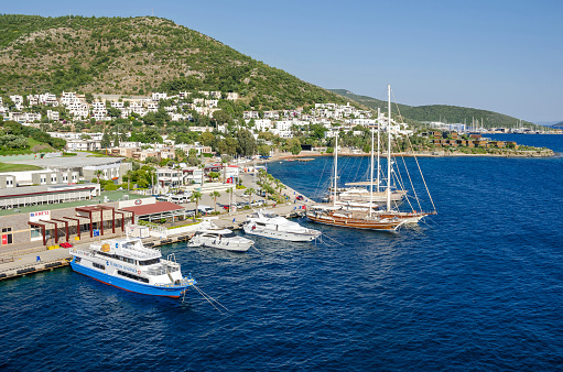 Bodrum: View of the white city of  Bodrum from the sea with the Gulet type schooners (a two-masted wooden sailing vessel), popular for tourist charters, ferry and motorboats.