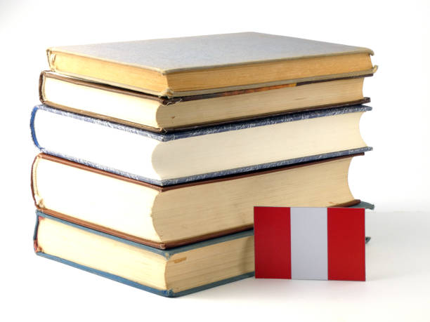 istock Peruvian flag with pile of books isolated on white background 843292958