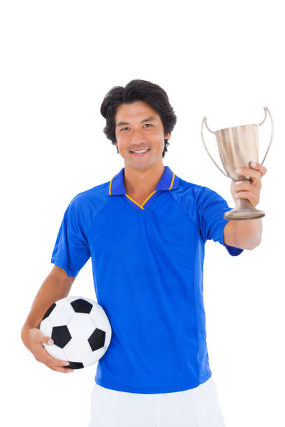 istock Football player in blue holding winners cup 843294242
