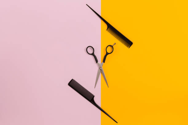 istock Barber set with two combs and scissors on pink and yellow background 843301246