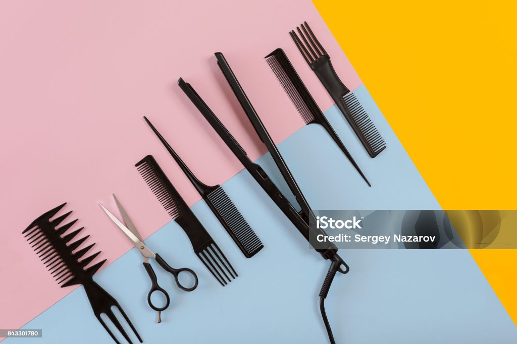 Various hair styling devices on the color blue, yellow, pink paper background, top view Various hair styling devices on the color blue, yellow, pink paper background, top view. Copy space. Still life. Mock-up. Flat lay Hair Stock Photo
