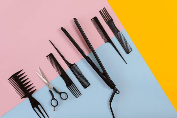 Various hair styling devices on the color blue, yellow, pink paper background, top view Various hair styling devices on the color blue, yellow, pink paper background, top view. Copy space. Still life. Mock-up. Flat lay scissors photos stock pictures, royalty-free photos & images