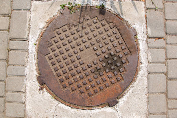The rusty manhole. The manhole, rusty with a square pattern. sewer lid stock pictures, royalty-free photos & images