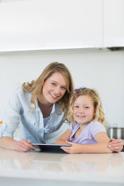 istock Mother and daughter with digital tablet 843312622