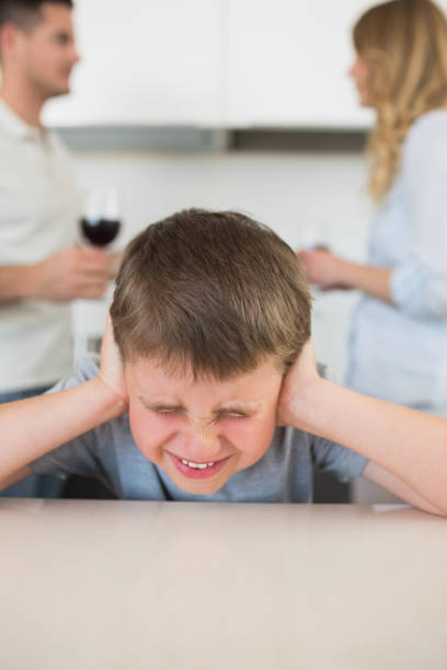 istock Furstrated boy covering ears while parents arguing 843313988