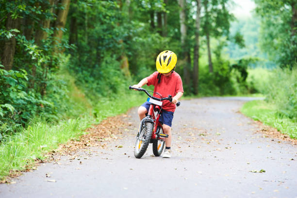 istock Child boy on a bicycle on bicycle path in summer. 843314526