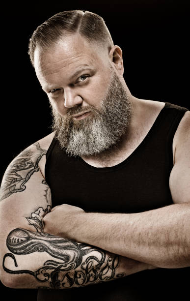 istock Handsome bearded tattooed middle aged man in studio shoot 843314546