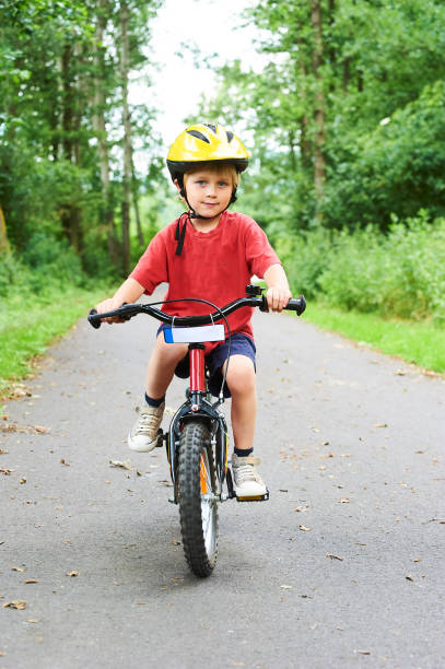 istock Child boy on a bicycle on bicycle path in summer. 843314616