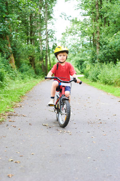 istock Child boy on a bicycle on bicycle path in summer. 843314630