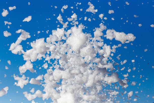 istock White foam against the blue sky as background 843315028