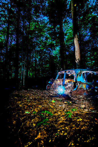An abandoned car in a wooded area in Quebec. Outdoor shooting.