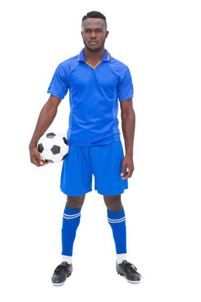istock Football player in blue standing with ball 843324298