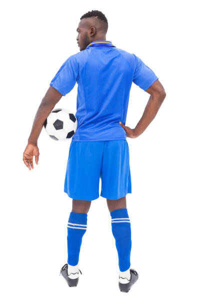istock Football player in blue standing with ball 843324350
