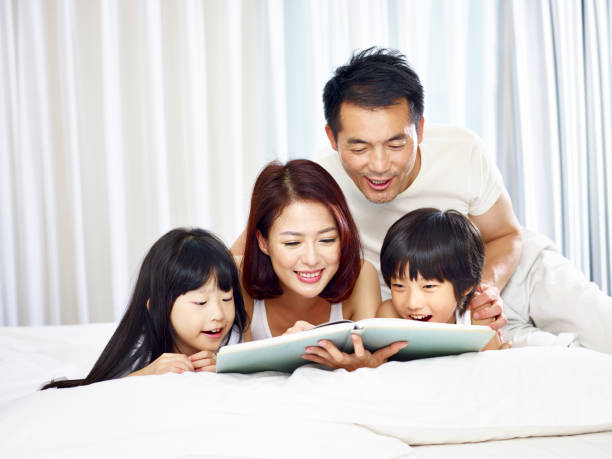 asian family reading book together