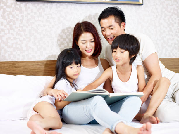 istock asian family reading book together 843330740