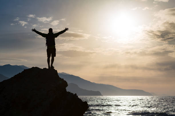 istock Man with arms outstretched celebrate mountains sunrise 843334650
