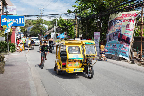 Motorized tricycle BORACAY, PHILIPPINES - MARCH 04: Tricycle on the street, March 04, 2013, Boracay, Philippines. Motorized tricycles are a common means of passenger transport everywhere in the Philippines. philippines tricycle stock pictures, royalty-free photos & images