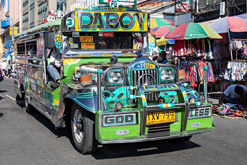 MANILA, PHILIPPINES - MARCH 17: Jeepney on Manila street on March, 17, 2013, Manila, Philippines. Jeepney is a most popular public transport on Philippines.