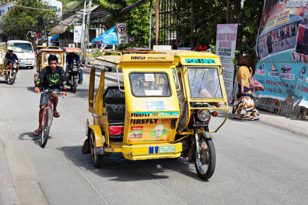 Motorized tricycle BORACAY, PHILIPPINES - MARCH 04: Tricycle on the street, March 04, 2013, Boracay, Philippines. Motorized tricycles are a common means of passenger transport everywhere in the Philippines. philippines tricycle stock pictures, royalty-free photos & images