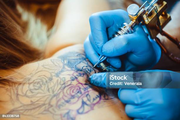 Master Tattoo Woman On Her Back Stock Photo - Download Image Now - Tattoo, Tattooing, Back